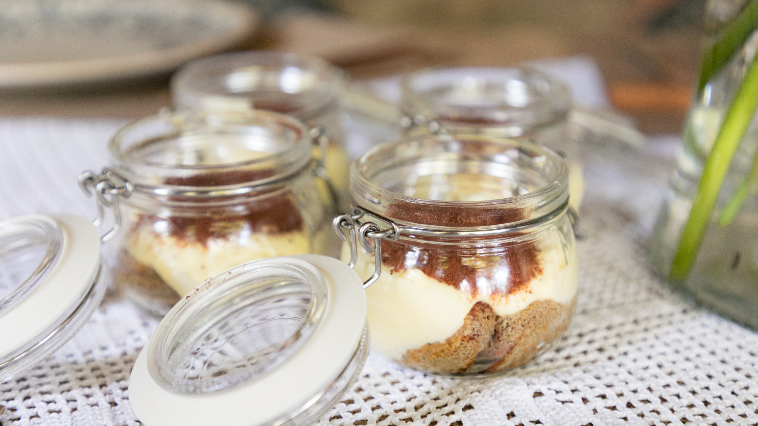 Homemade tiramisu delight: A creamy, coffee-infused Italian classic in charming glass jars!