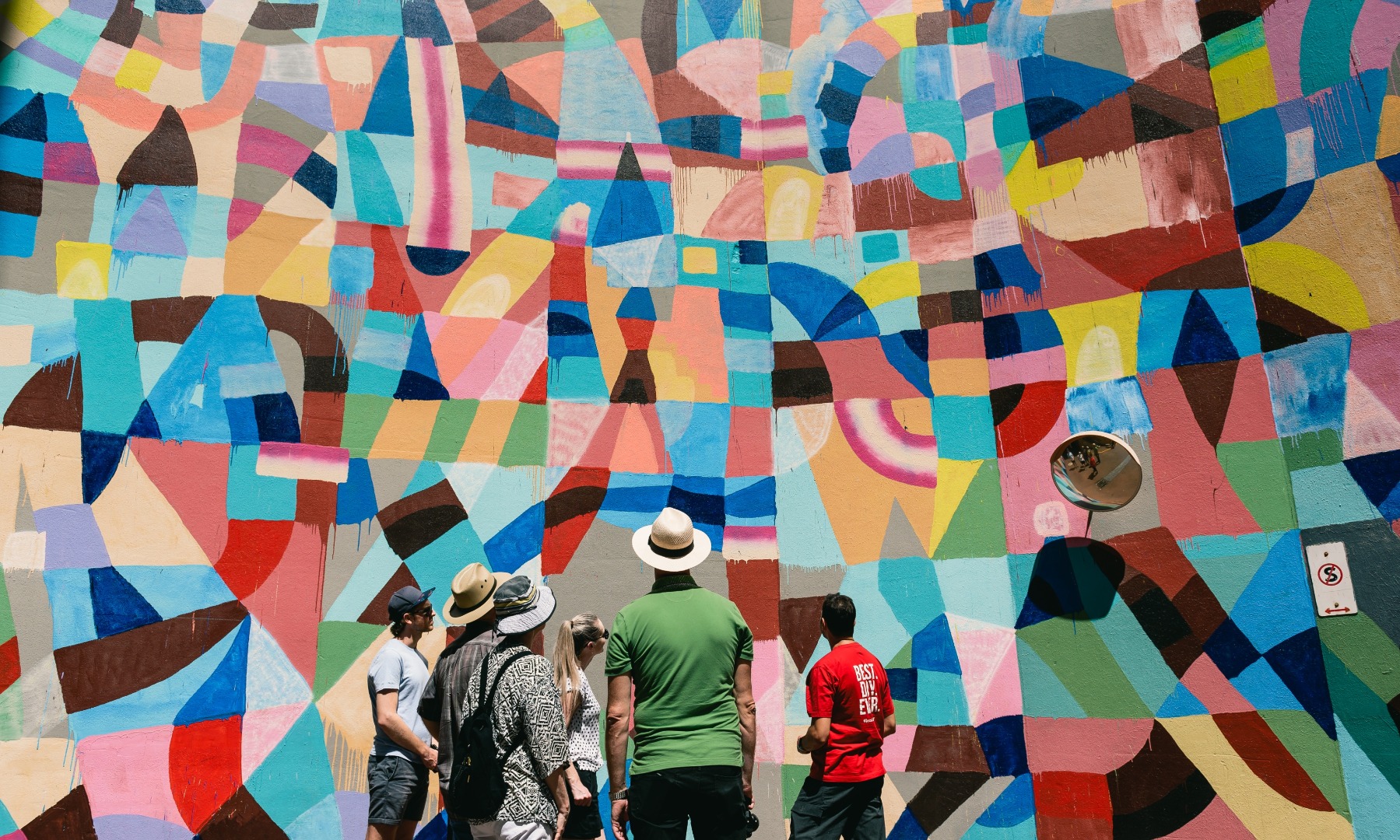 people admiring abstract street art