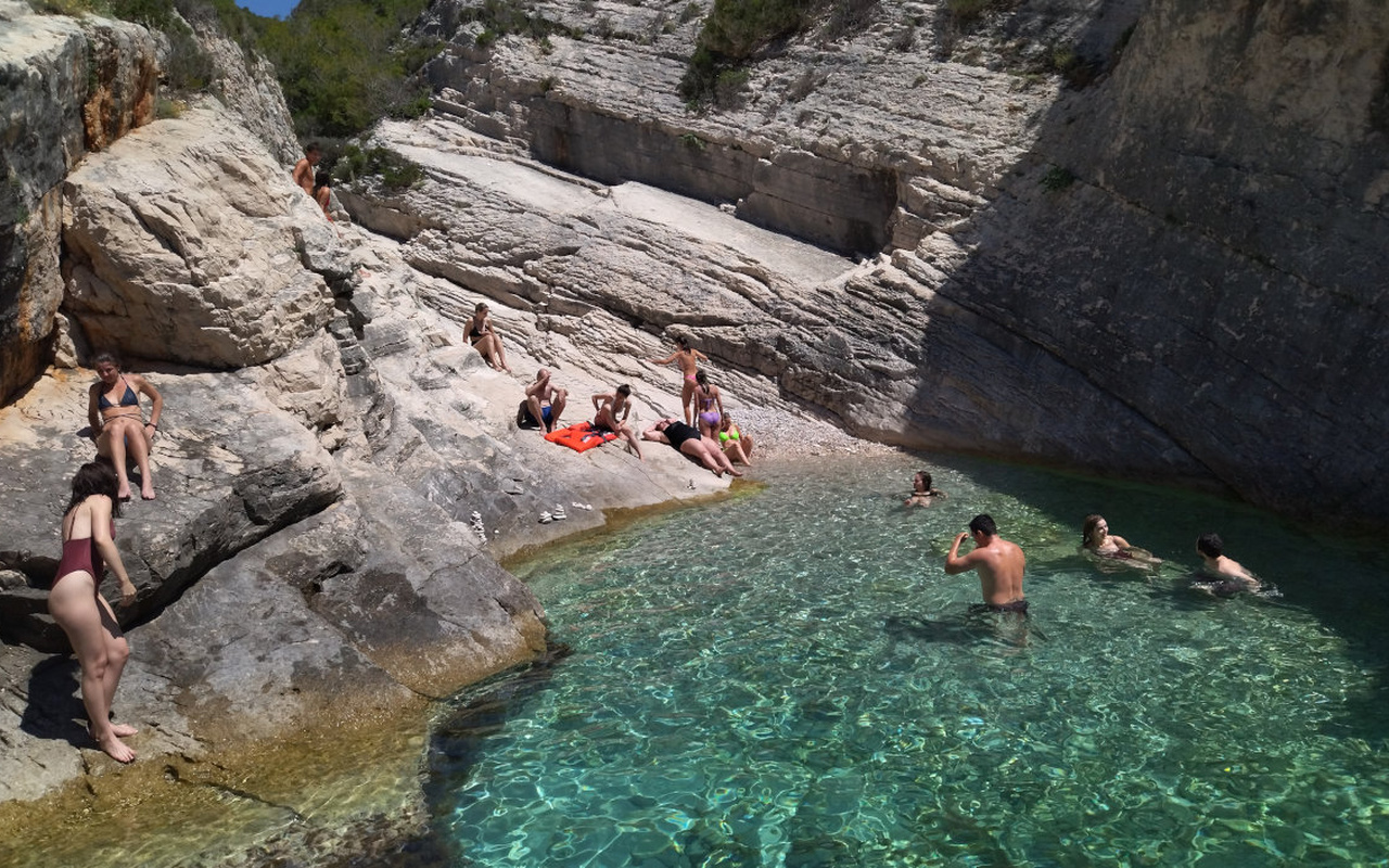Swim and relax in a secluded cove surrounded by dramatic rocky cliffs