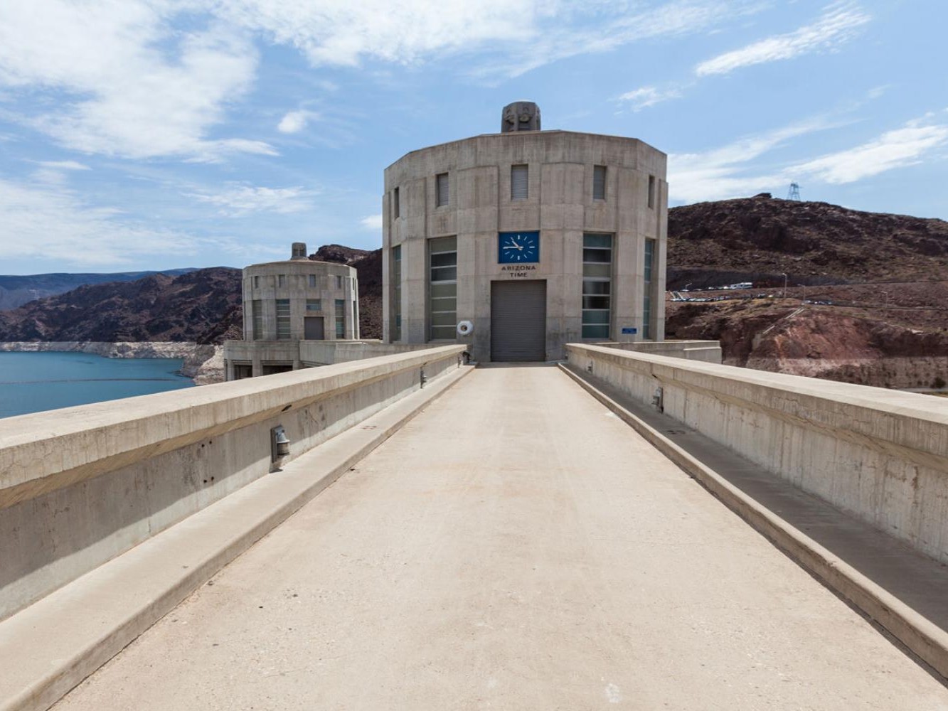 Capture Hoover Dam’s imposing structure rising majestically against a backdrop of Nevada desert