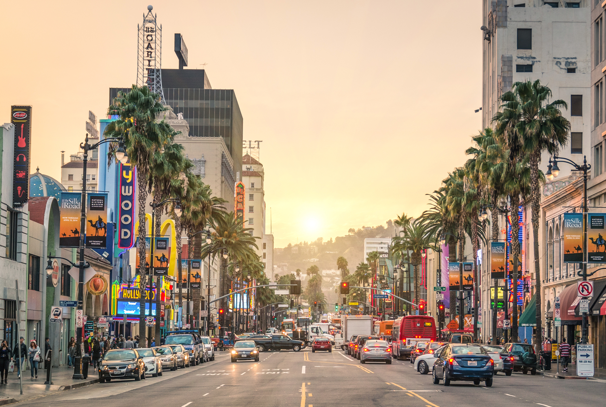 Admire the bustling streets and iconic theaters surrounding the Hollywood Walk of Fame