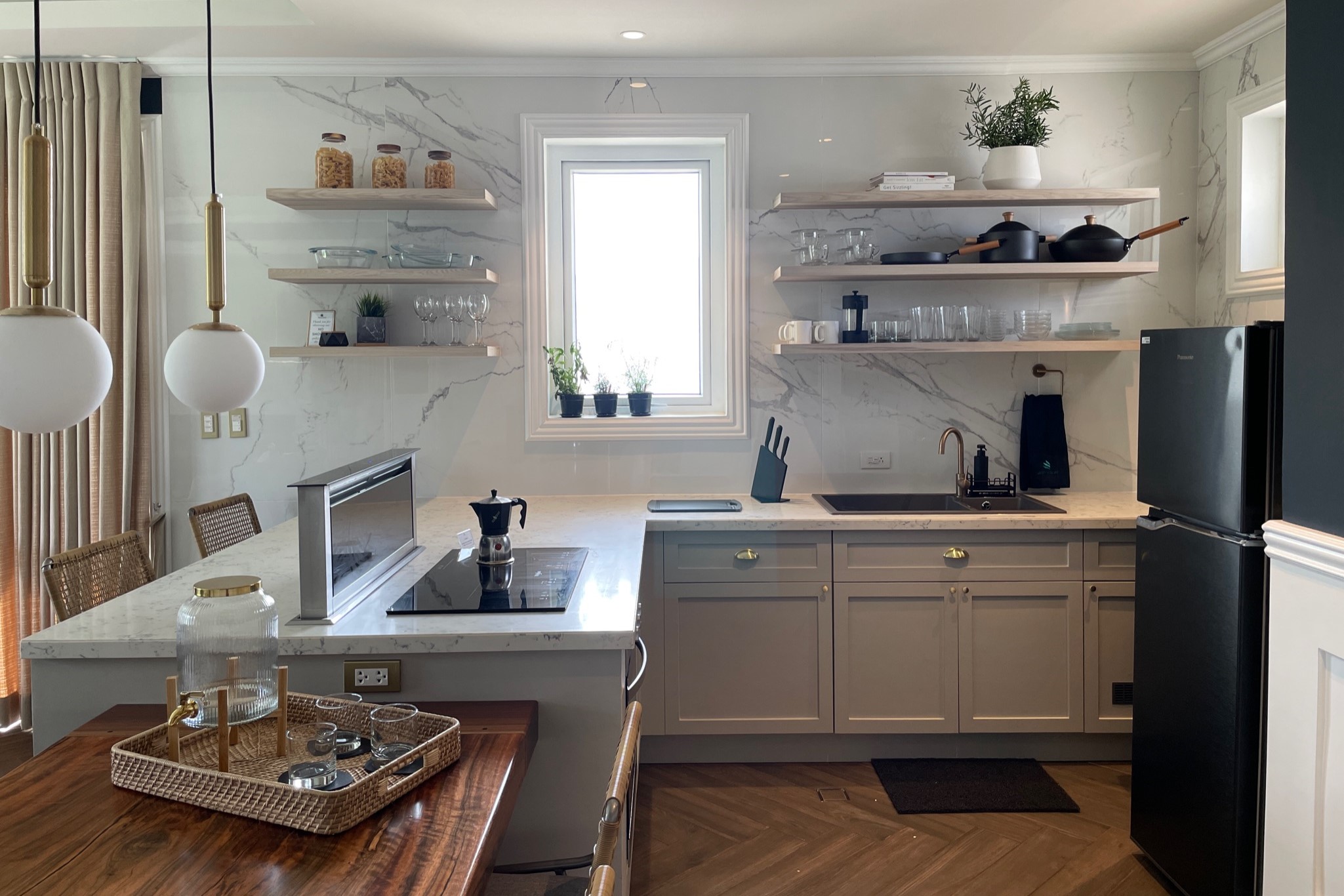 A kitchen with sink, fridge, and table