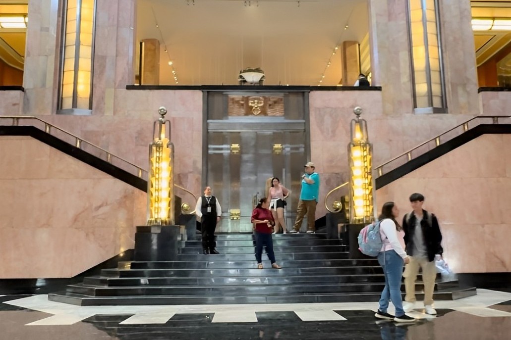 Tourists taking pictures of intricate architectural details adorning the museum walls