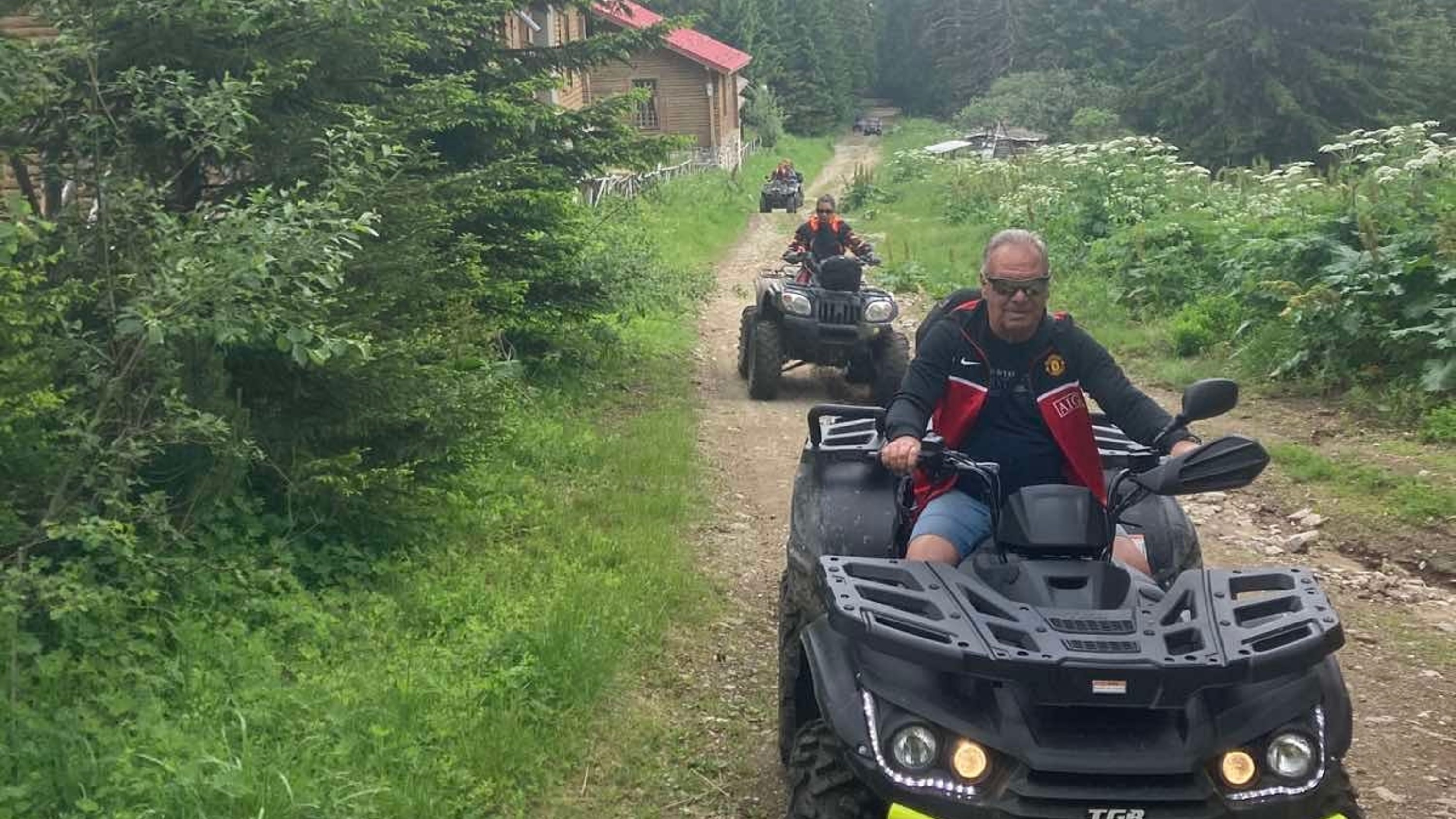 Guests riding quads along scenic green trails, surrounded by nature and fresh mountain air