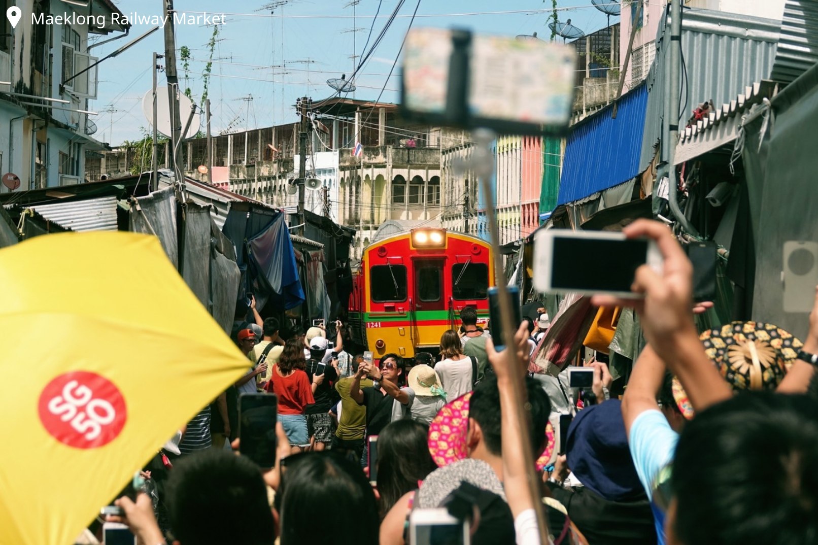 Take the 19th local train running through the middle of the market, as the locals perform their routine of moving their stalls