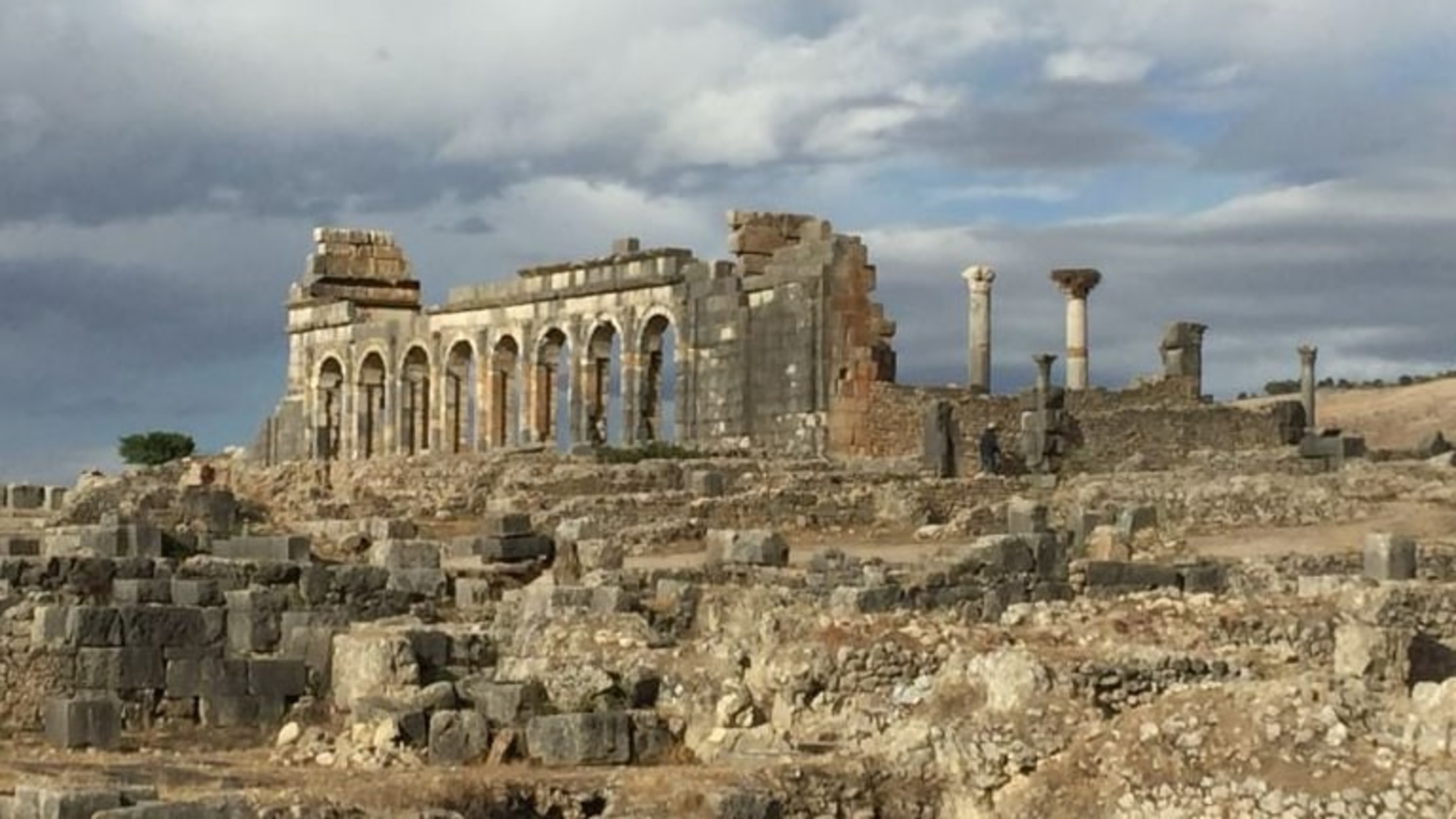 Wander through the majestic Roman ruins of Volubilis, surrounded by ancient mosaics and columns