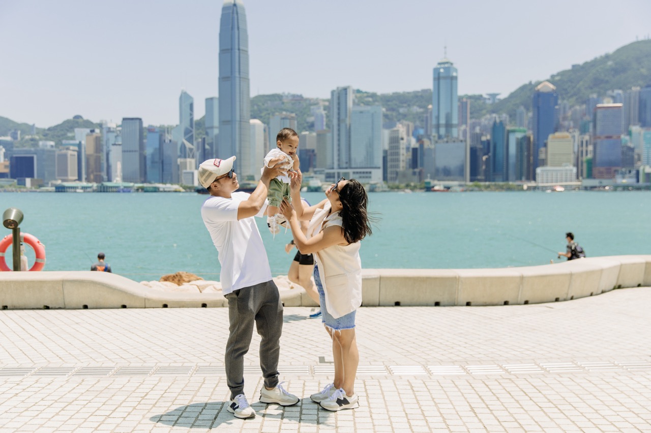 A fun family photo with the majestic skyline of Victoria Harbour reflecting the joy of your unforgettable day.
