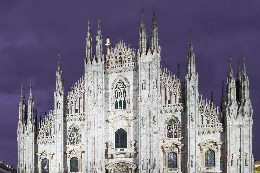 The towering spires of Milan's Duomo dominate the skyline in grandeur