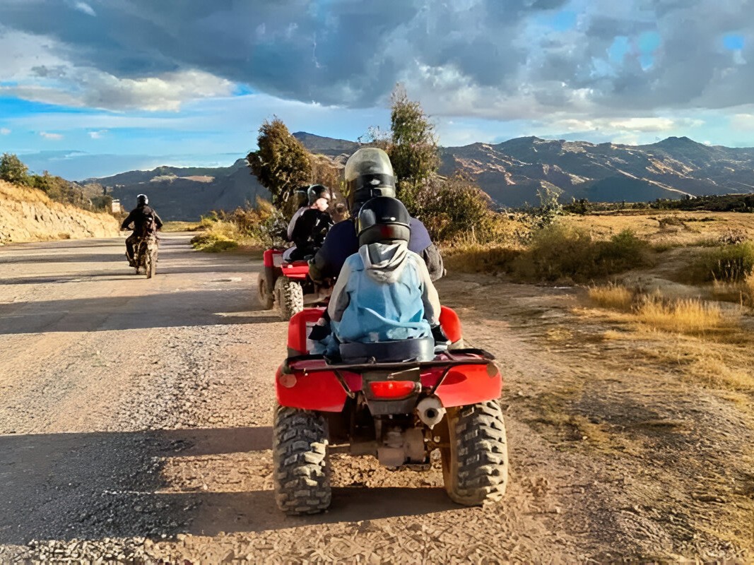 Travelers pausing for a scenic photo at a hilltop with breathtaking valley views