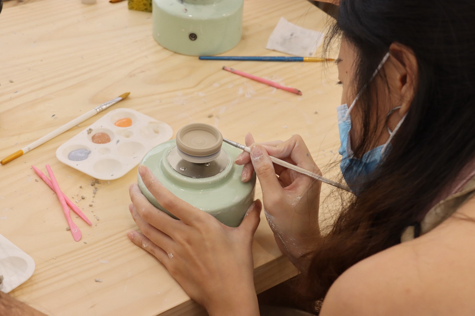 A participant shaping her tiny creation during our Mini Pottery Workshop — proof that small things bring big joy.