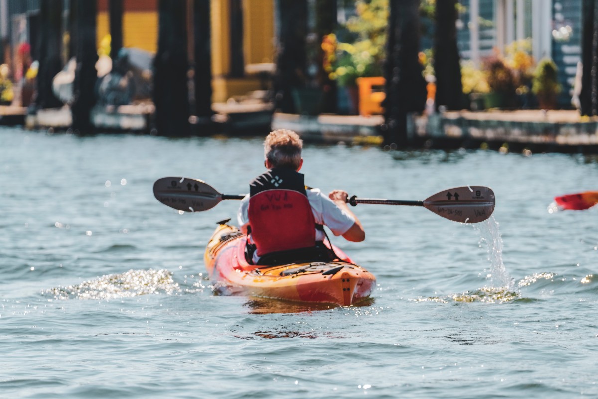 Kayaking beneath the fading sunlight, embracing the serenity of Vancouver’s coastal charm