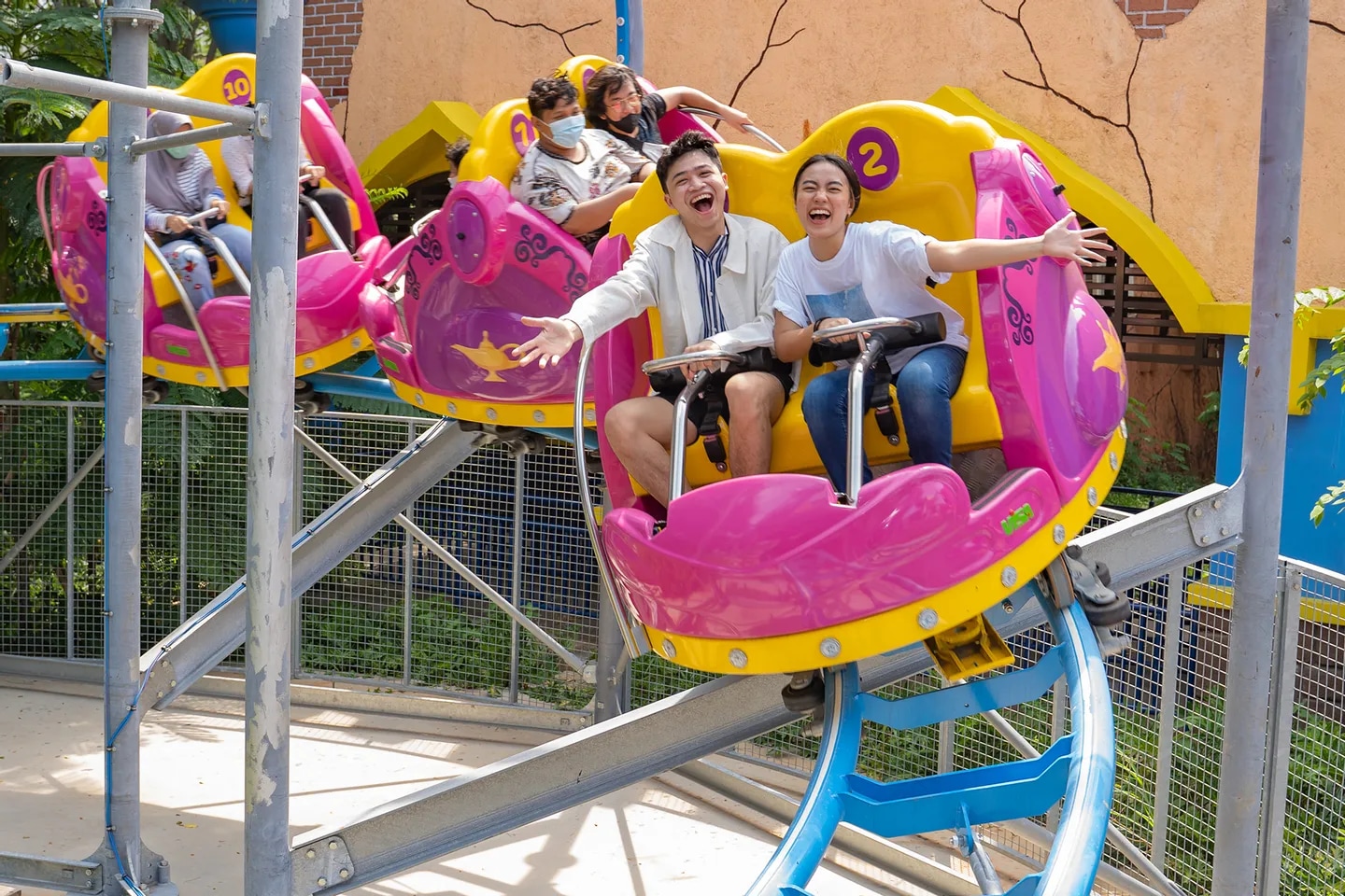 孩子們和家人們在一個色彩繽紛的旋轉游樂設施上玩耍
