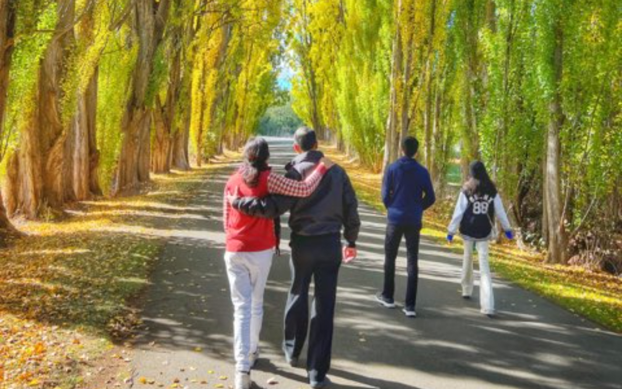 Savoring these precious moments walking amongst the vibrant autumn trees together