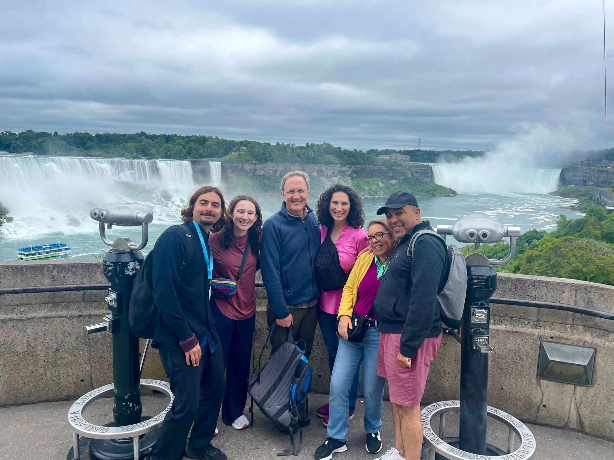 A family takes a break from the walk to pose with their guide at one of our scenic lookout stops.