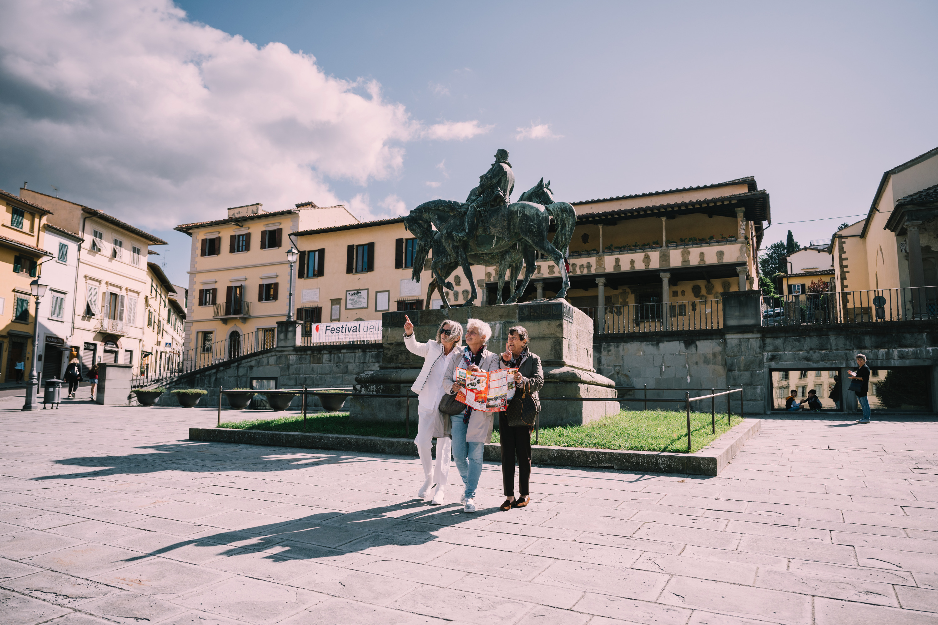 Women standing in front of a statue