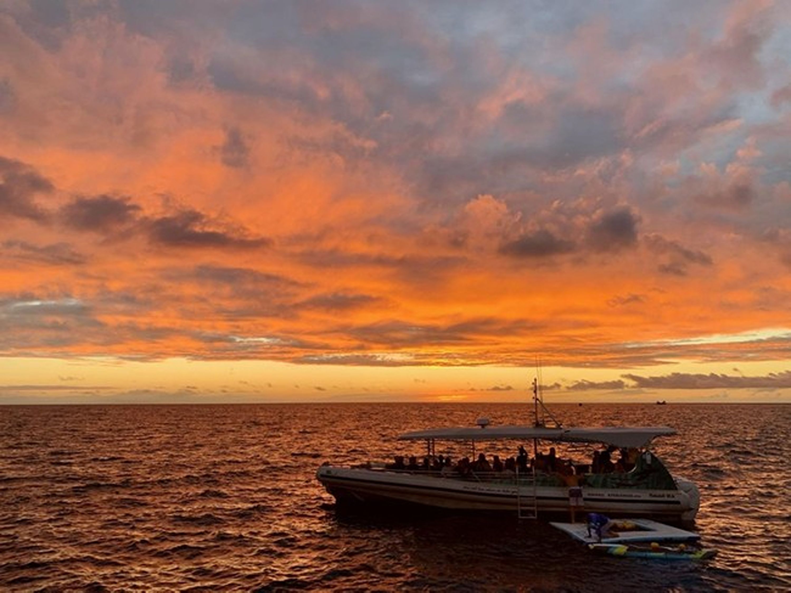 Guests enjoying breathtaking sunset views aboard KIBOU along the Big Island’s western coast