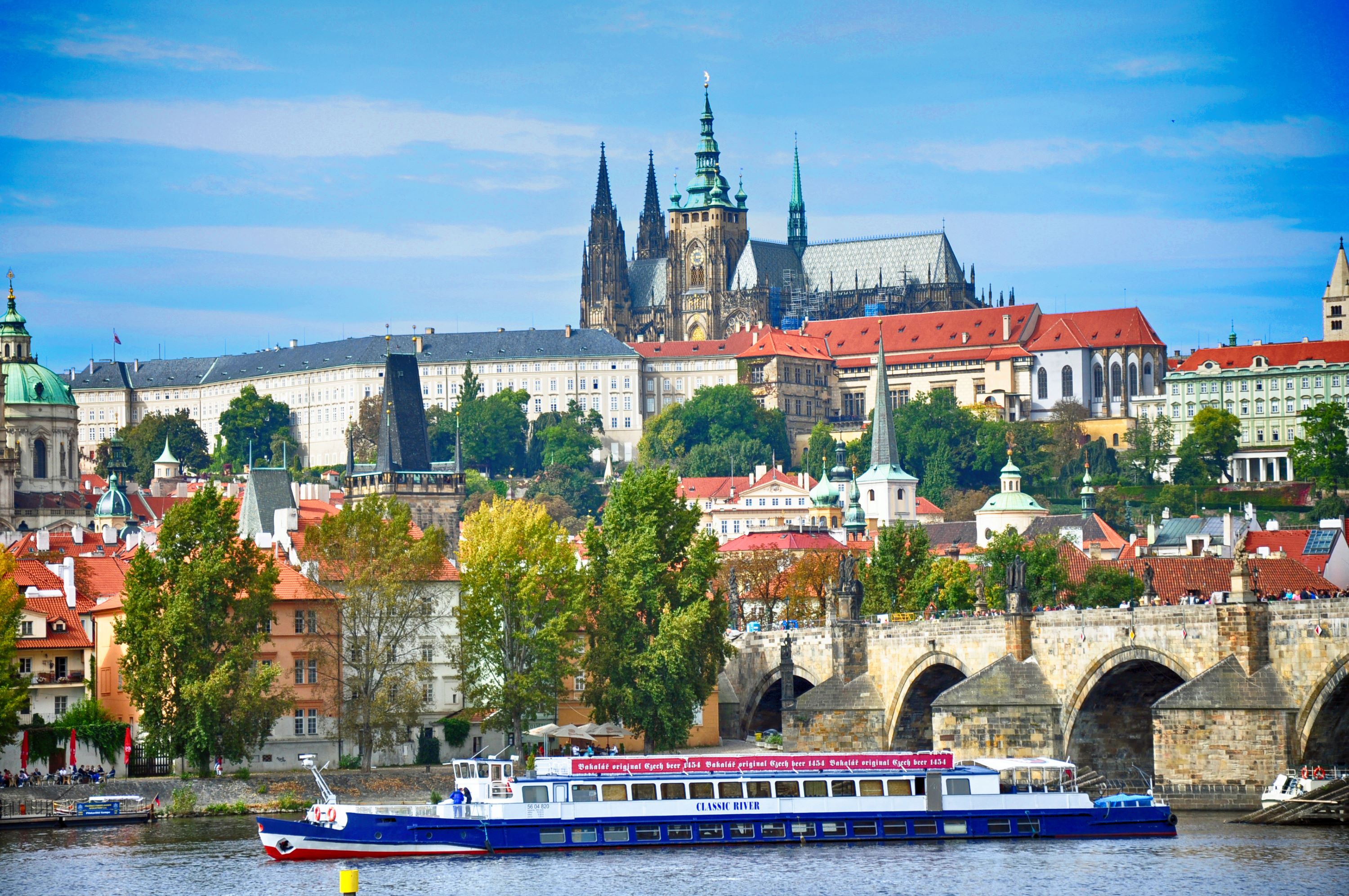 a ship along River Vltava with prague sklyline as backdrop