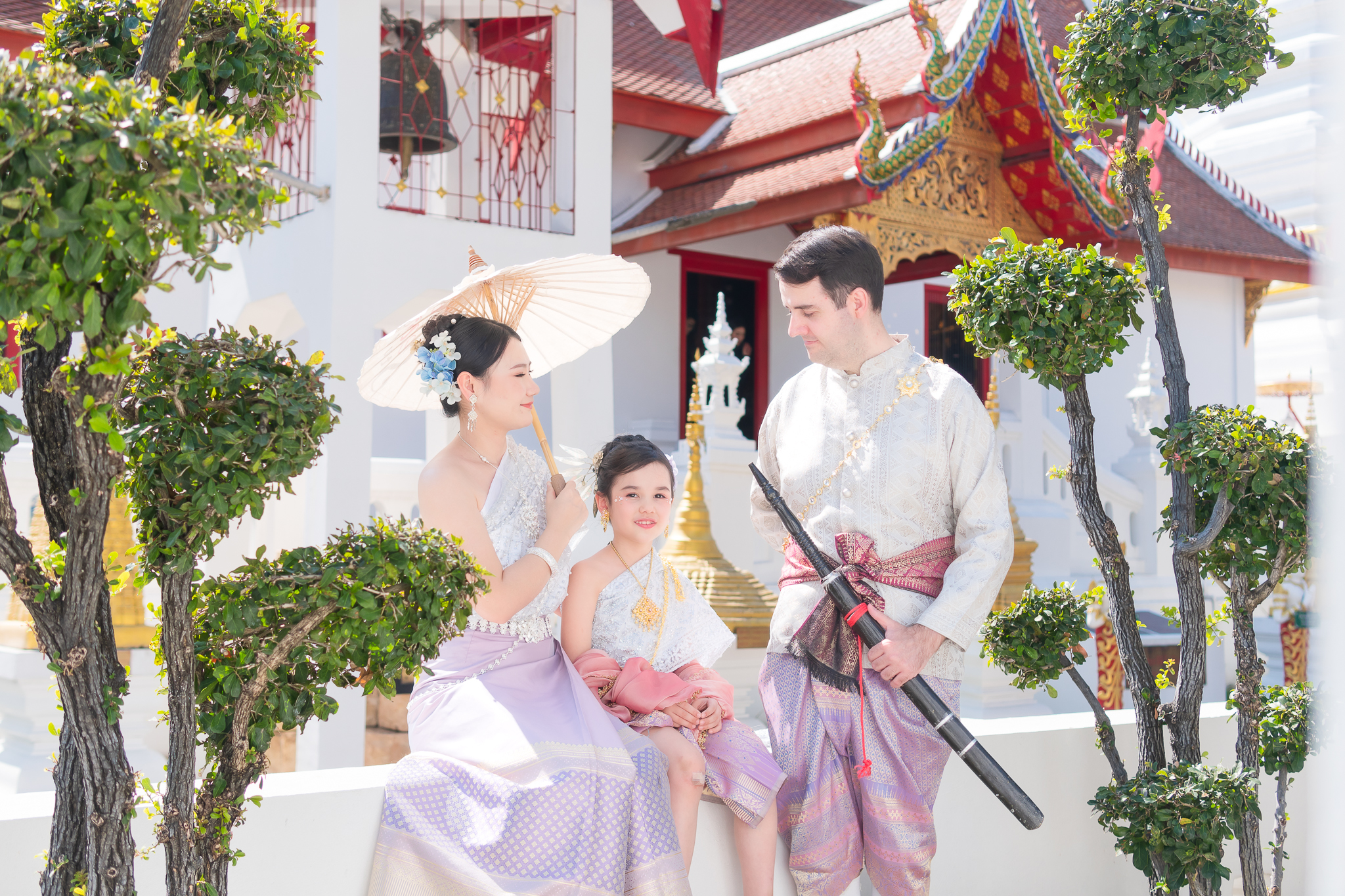 A loving family in timeless Thai elegance.