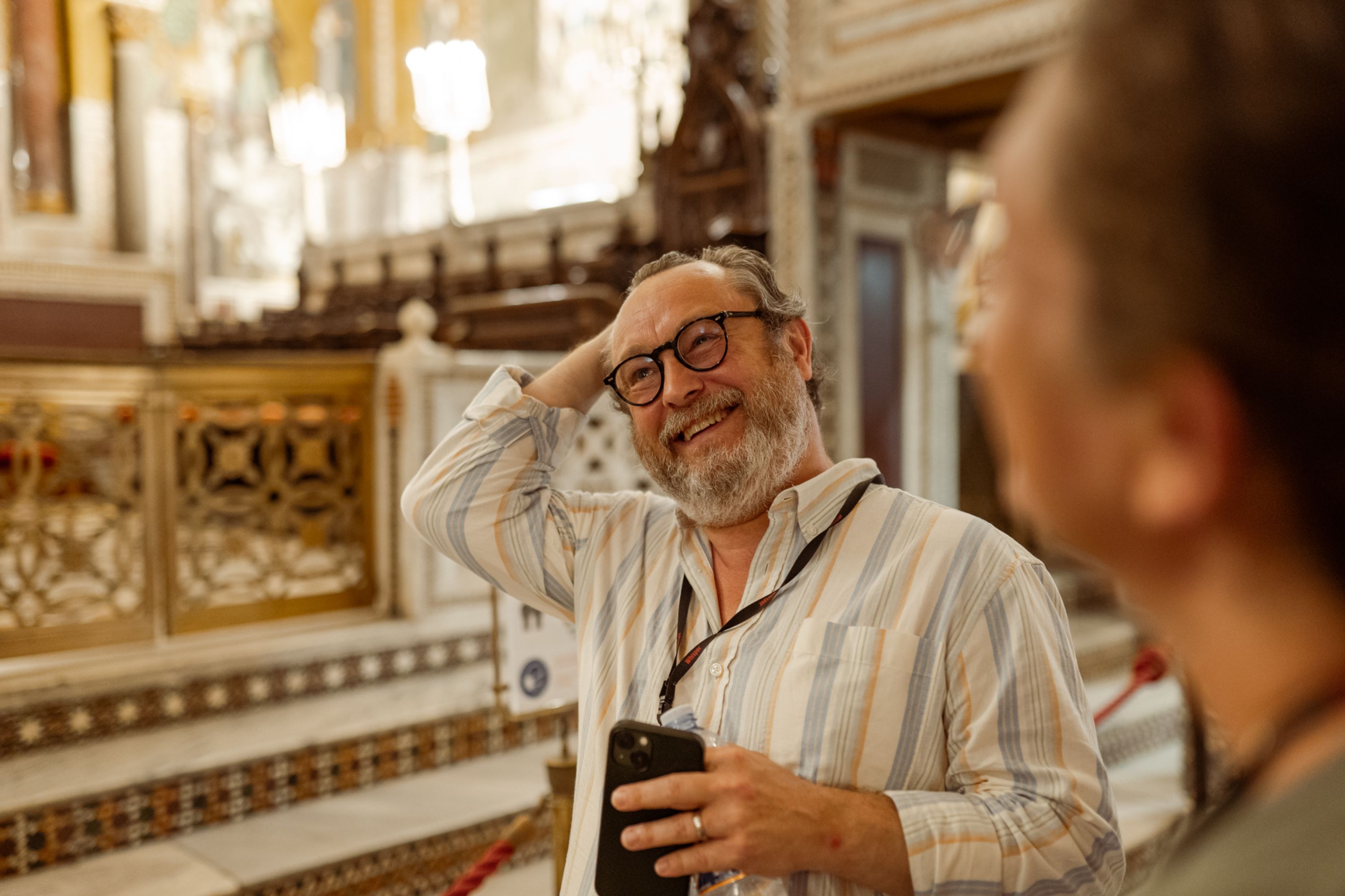 Engage with the guide, asking questions to deepen your understanding of the site's significance