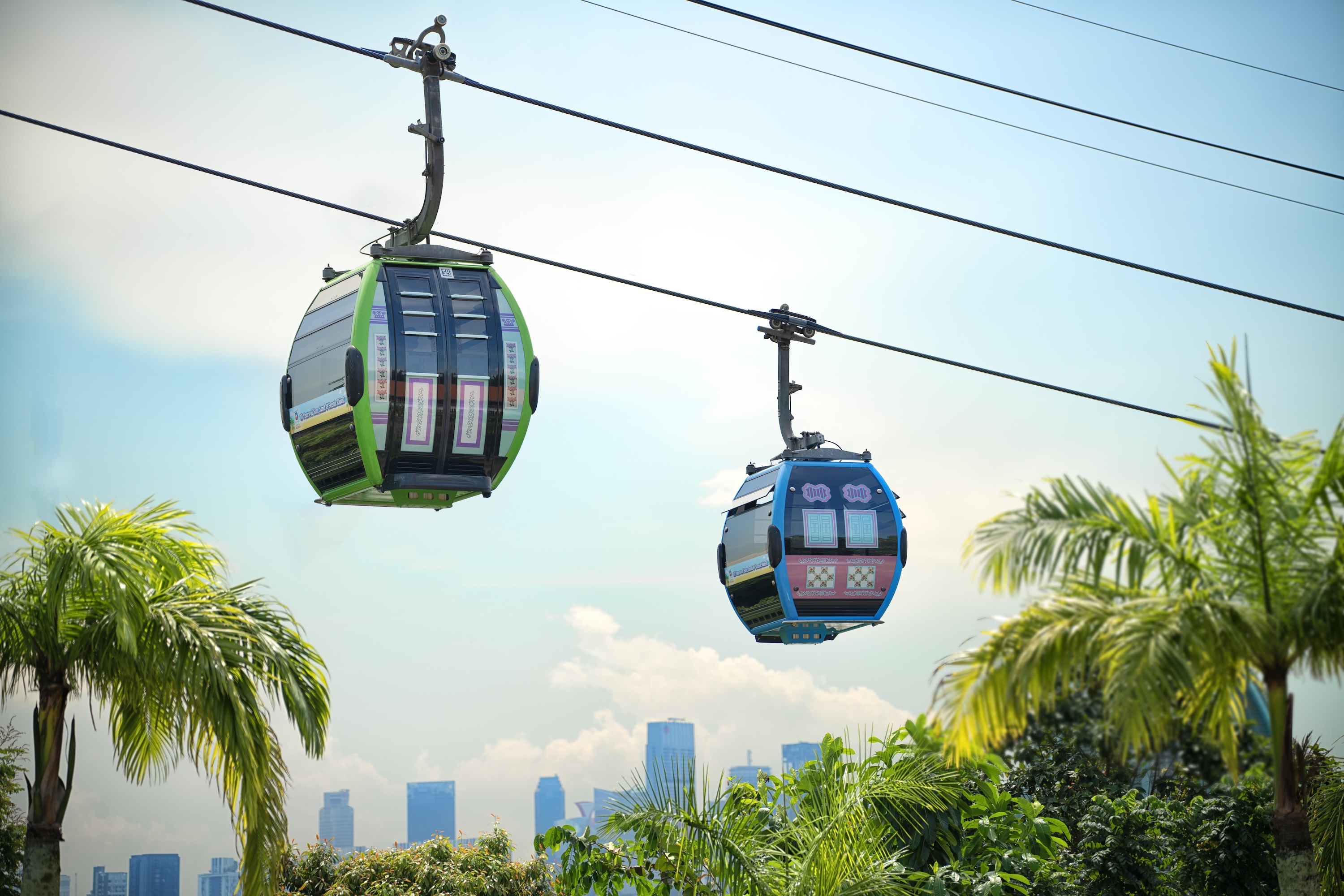 Ride in Peranakan-inspired cable cars—adorned in pastel hues, ornate tiles, and shophouse motifs soar over golden beaches and lush forests in this moving tribute to heritage