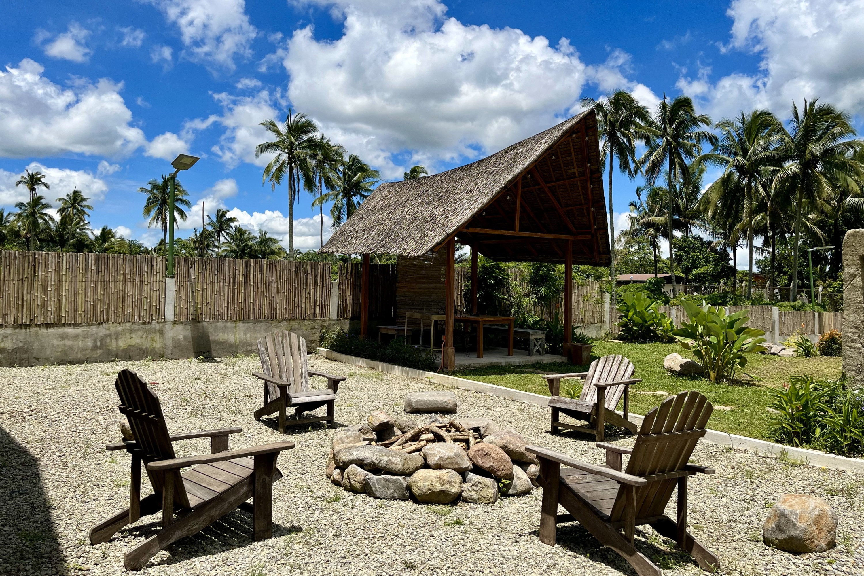 Campfire set up with wooden chairs around it