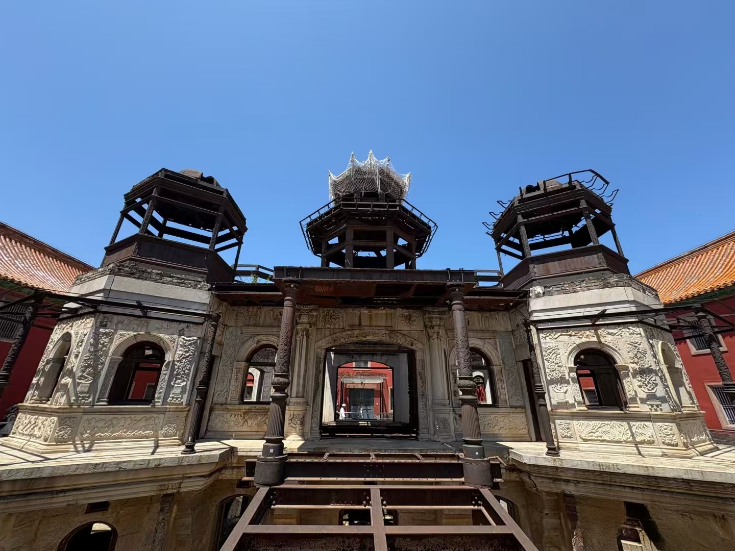 故宮延禧宮的靈沼軒（水晶宮）中西合璧，漢白玉雕花與鐵藝框架交織，殘損的穹頂與紅牆相映，訴說著百年曆史滄桑