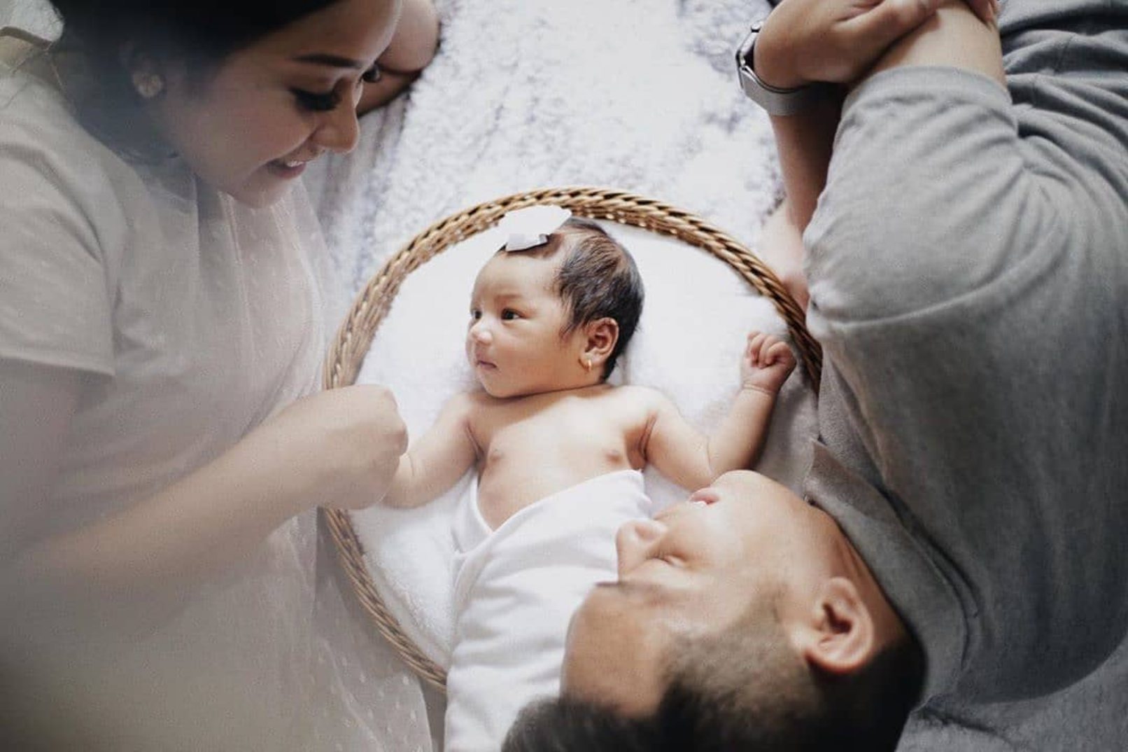 Parents with baby in bed