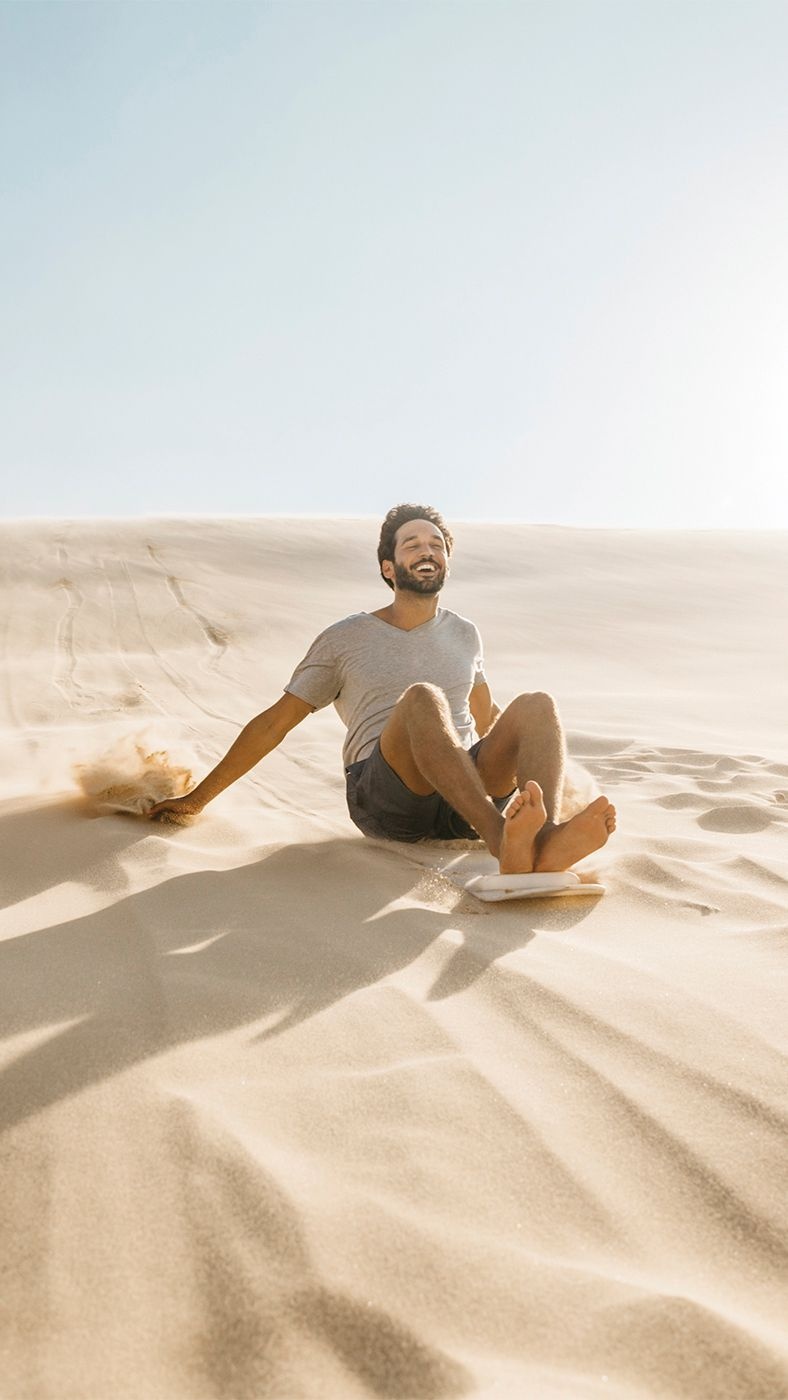 Enjoy sliding down the sand dunes on a board 
Photo Credit: Destination NSW