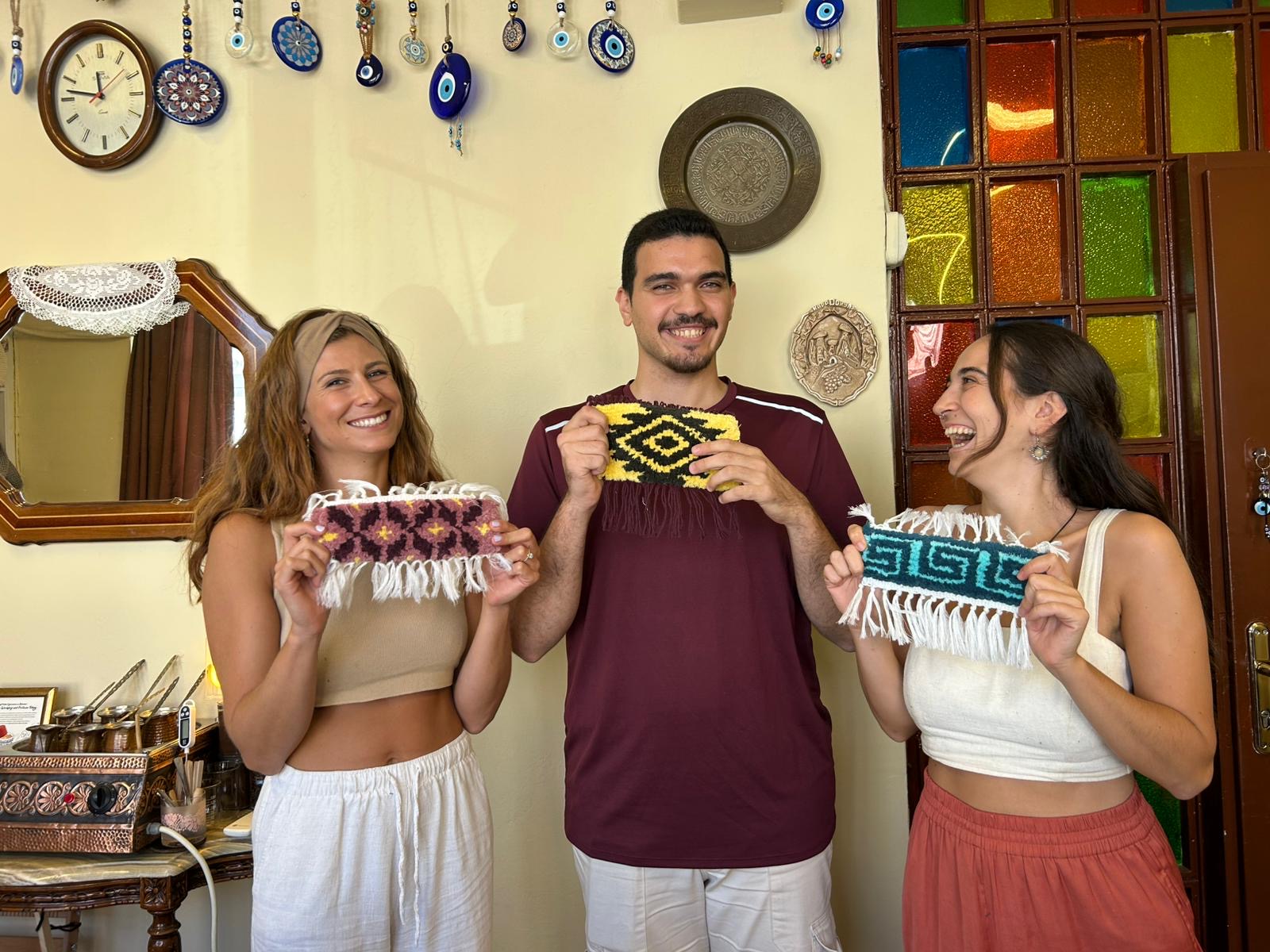 A proud moment — holding up our finished handmade carpets!