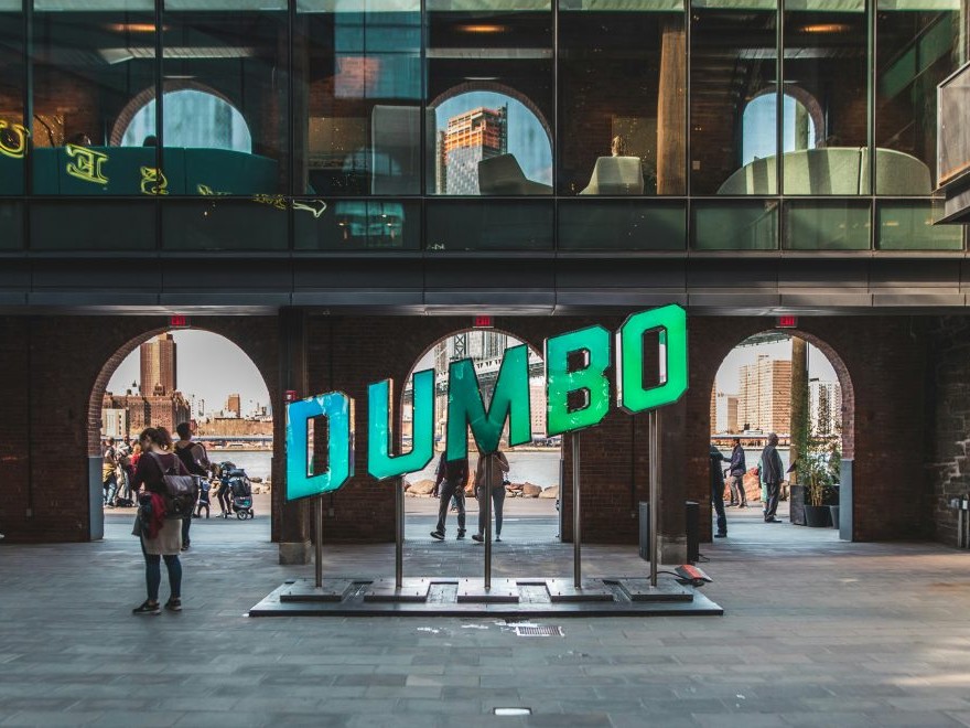 Capture a perfect photo at the iconic DUMBO sign with city views