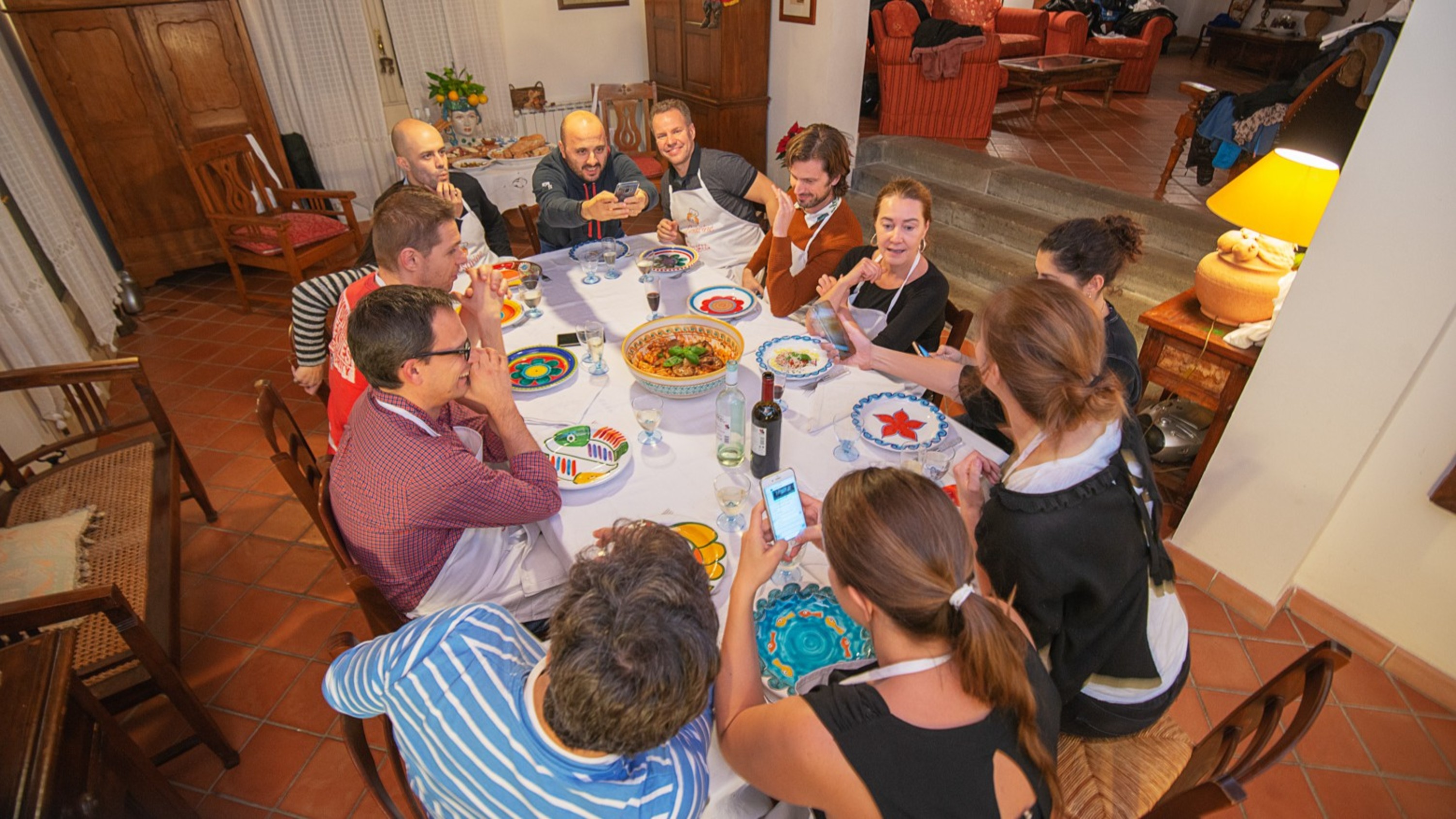 A joyful gathering around the table, sharing homemade Italian dishes and unforgettable moments