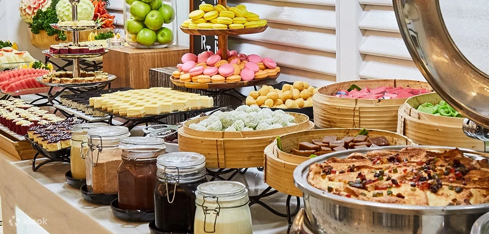 a buffet spread including fruits, pastries, meat, sauces in a mason jar 