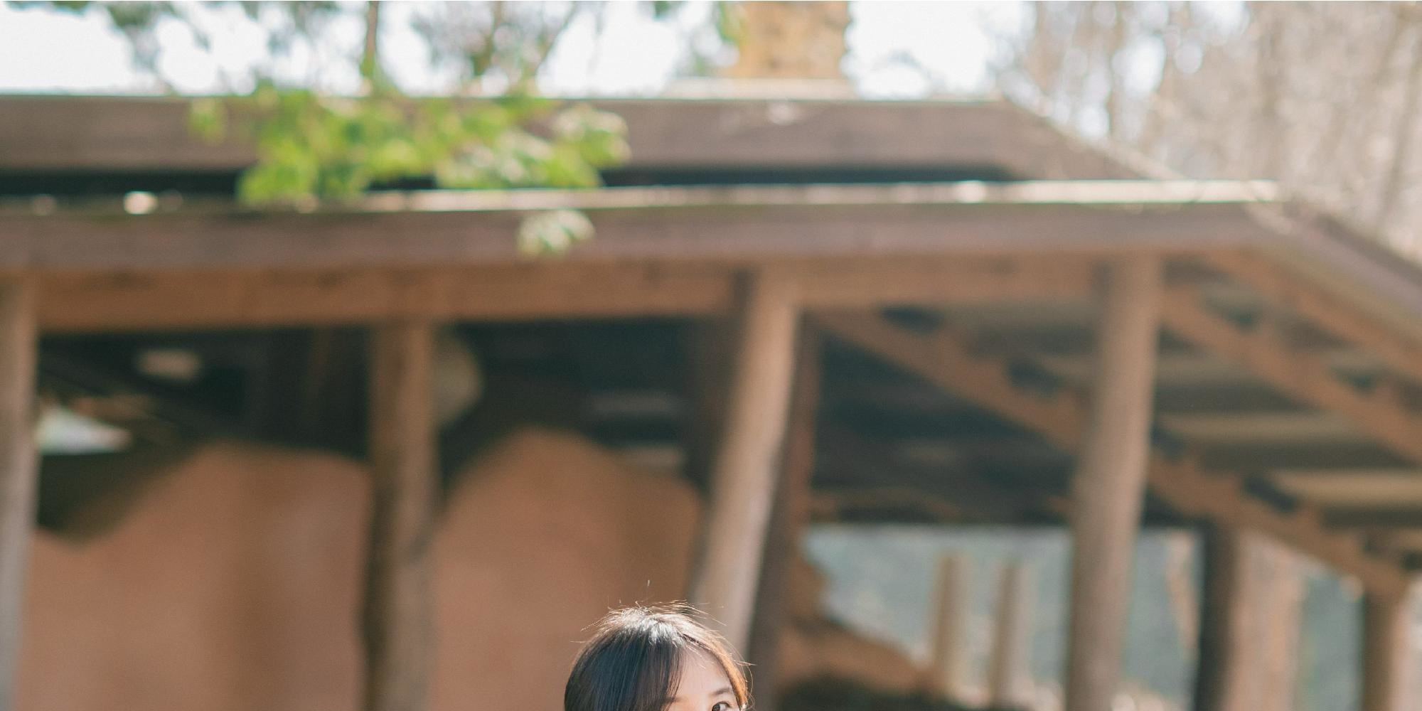 The hanbok’s vibrant colors blend perfectly with the spring scenery.