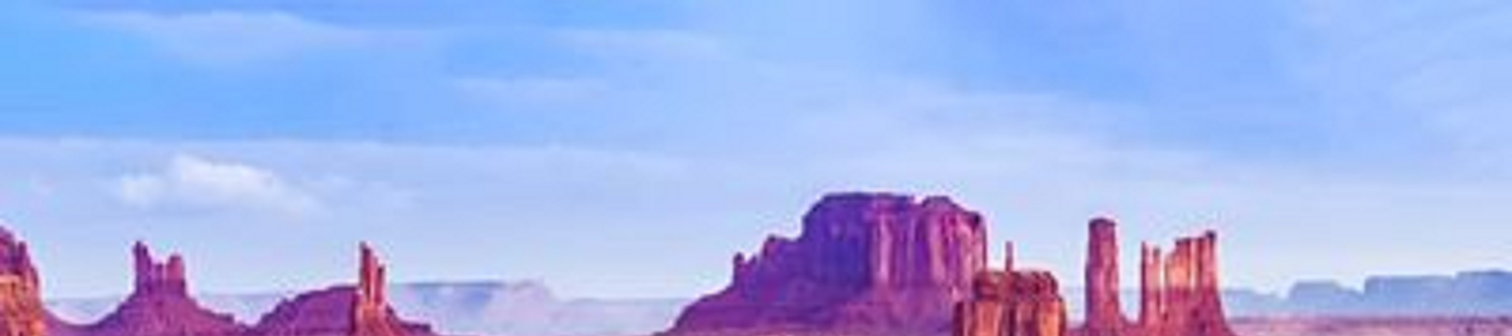 The vast desert landscape and towering buttes of Monument Valley, a famous icon of the American Southwest