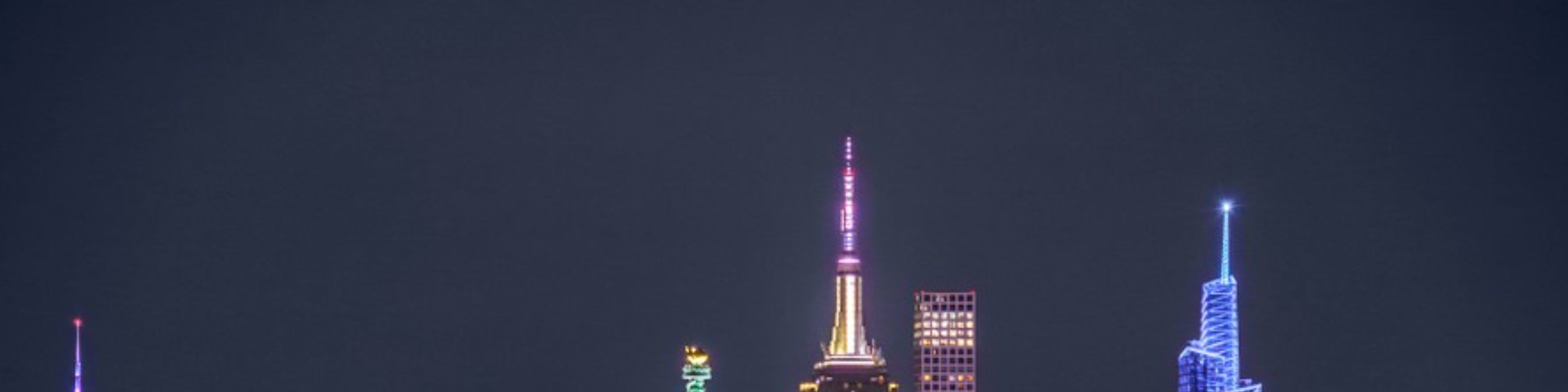 Majestic nighttime view of the Statue of Liberty glowing proudly in New York Harbor