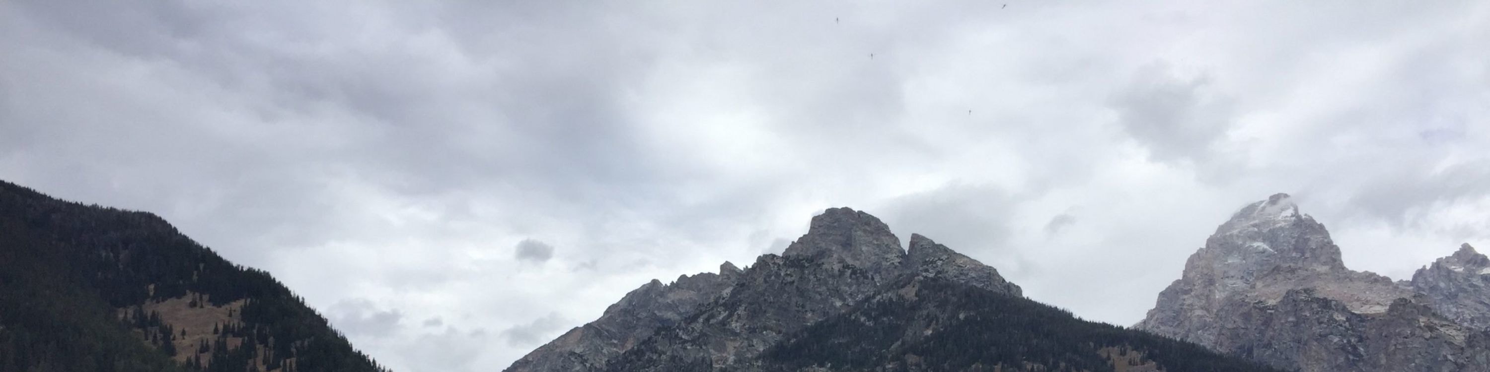 Scenic Grand Teton National Park lake view framed by towering rugged peaks