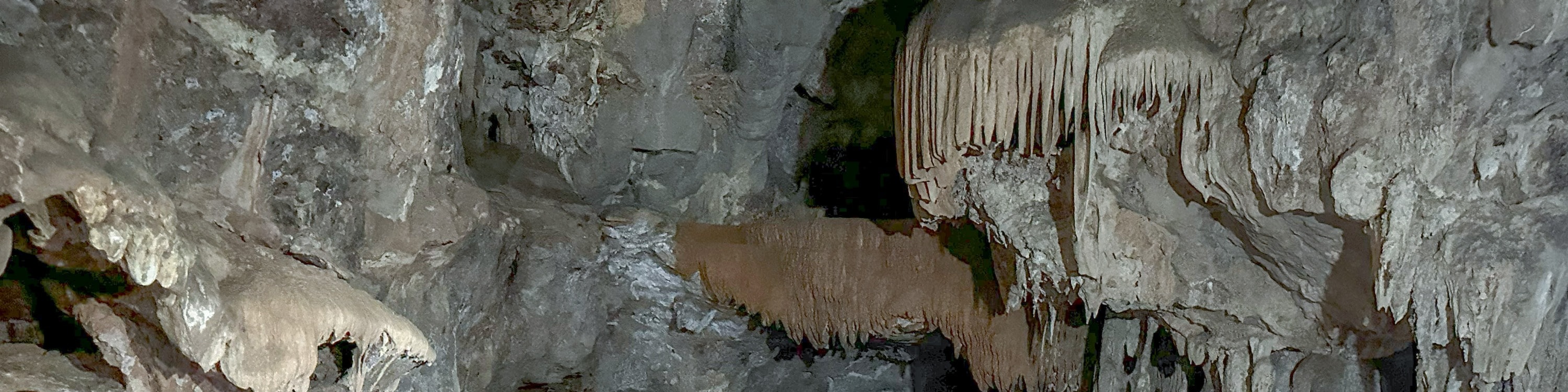 Discover the captivating inner realm of the cave, adorned with diverse stalagmites and stalactites, some resembling enchanting corals found in the depths of the sea.
