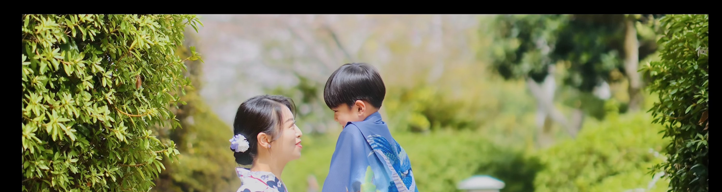A child fidgets with a collar — yet nothing can steal the father’s gaze, lingering on the mother like light on film.