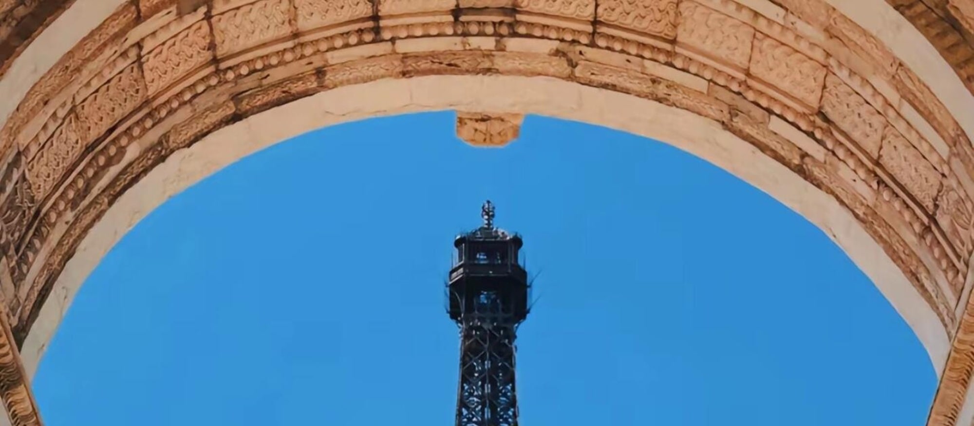 During the day, the Window of the World Tower frames the blue sky; at night, neon lights illuminate the global dream