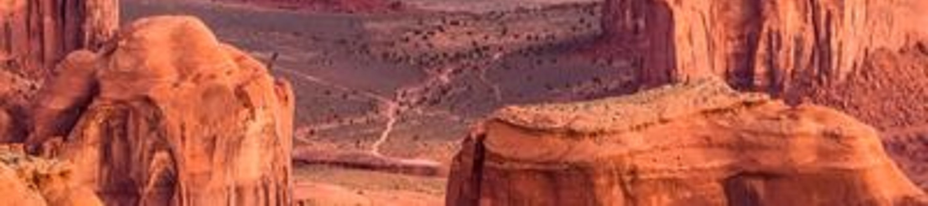 The vast desert landscape and towering buttes of Monument Valley, a famous icon of the American Southwest