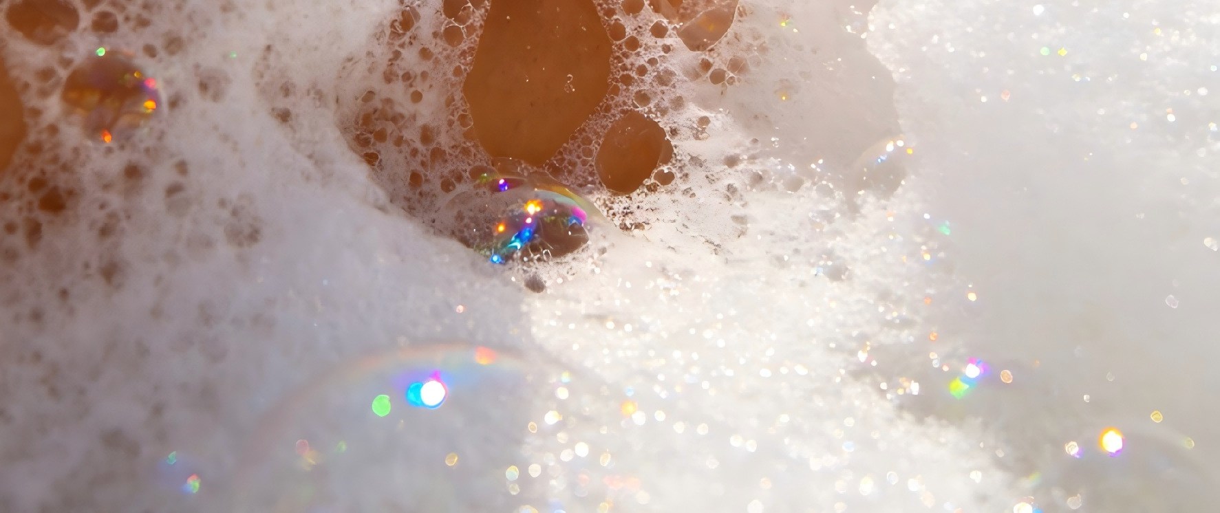 A close-up shot of a Fethiye bubble boat party, with crystal-clear bubbles enveloping ice drinks in tourists' hands, and iridescent bubbles refracting the sunlight, creating a full sense of summer relaxation.