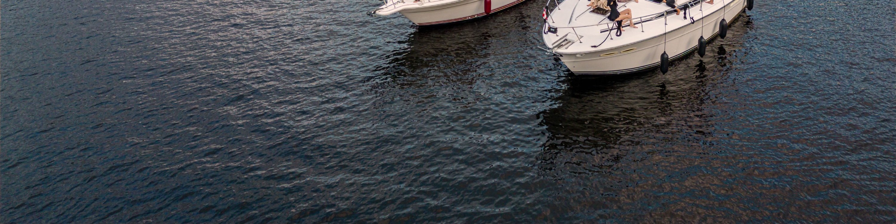 Elegant yacht docked at marina with golden evening sunlight reflecting on calm water