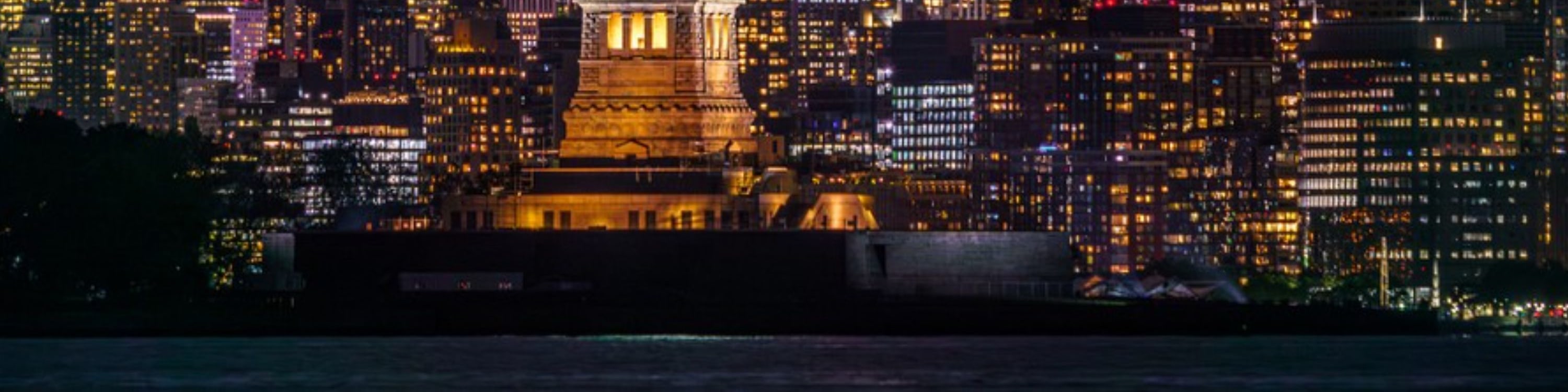 Majestic nighttime view of the Statue of Liberty glowing proudly in New York Harbor