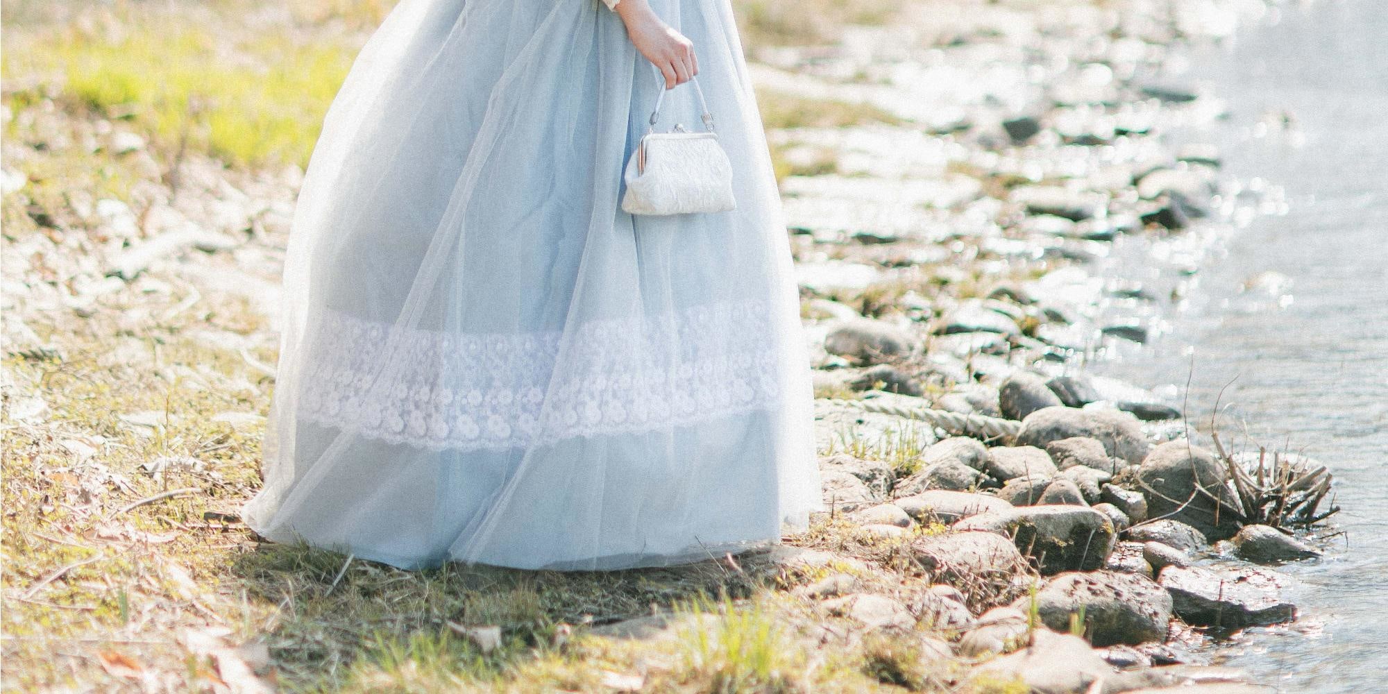 Hanbok flowing in the breeze under falling petals is a breathtaking sight.