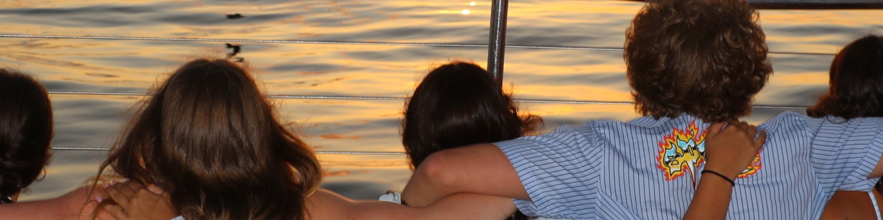 Guests often gather on the open deck to capture stunning photos of Oahu’s colorful sunset