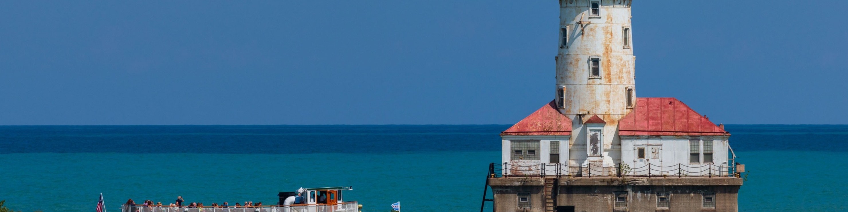 Admire the historic Chicago Harbor Lighthouse shining brilliantly across Lake Michigan waters