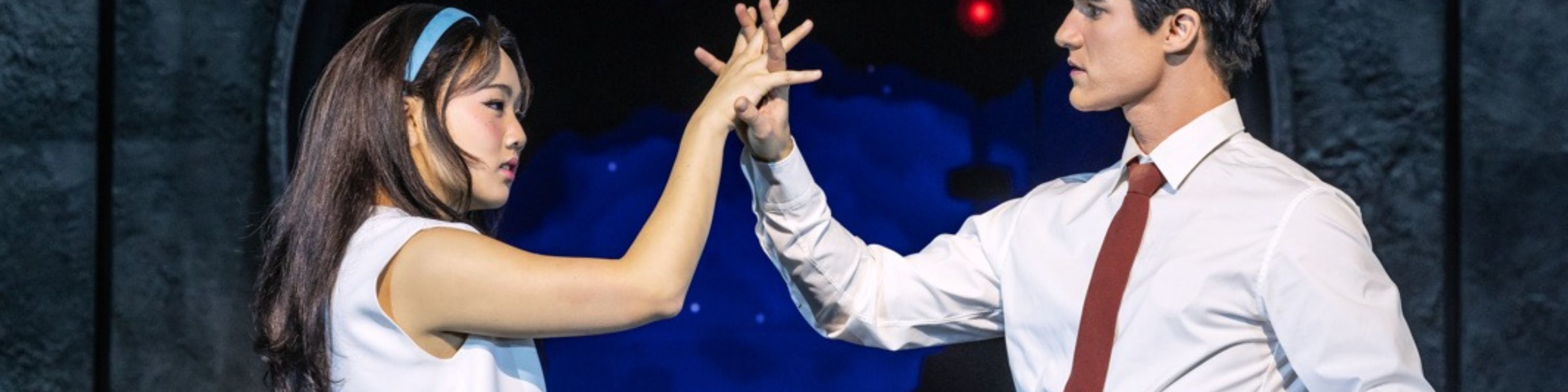 Oliver and Claire dance under soft lights in a moment of hopeful joy