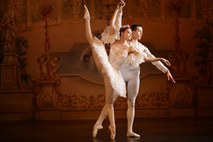 Principal couple in ivory and gold costumes in an