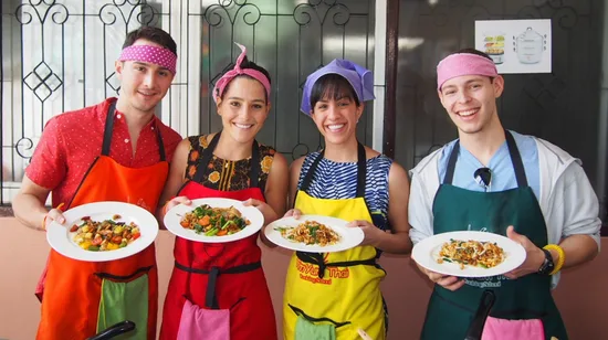 tourists pose for a photo after cooking class