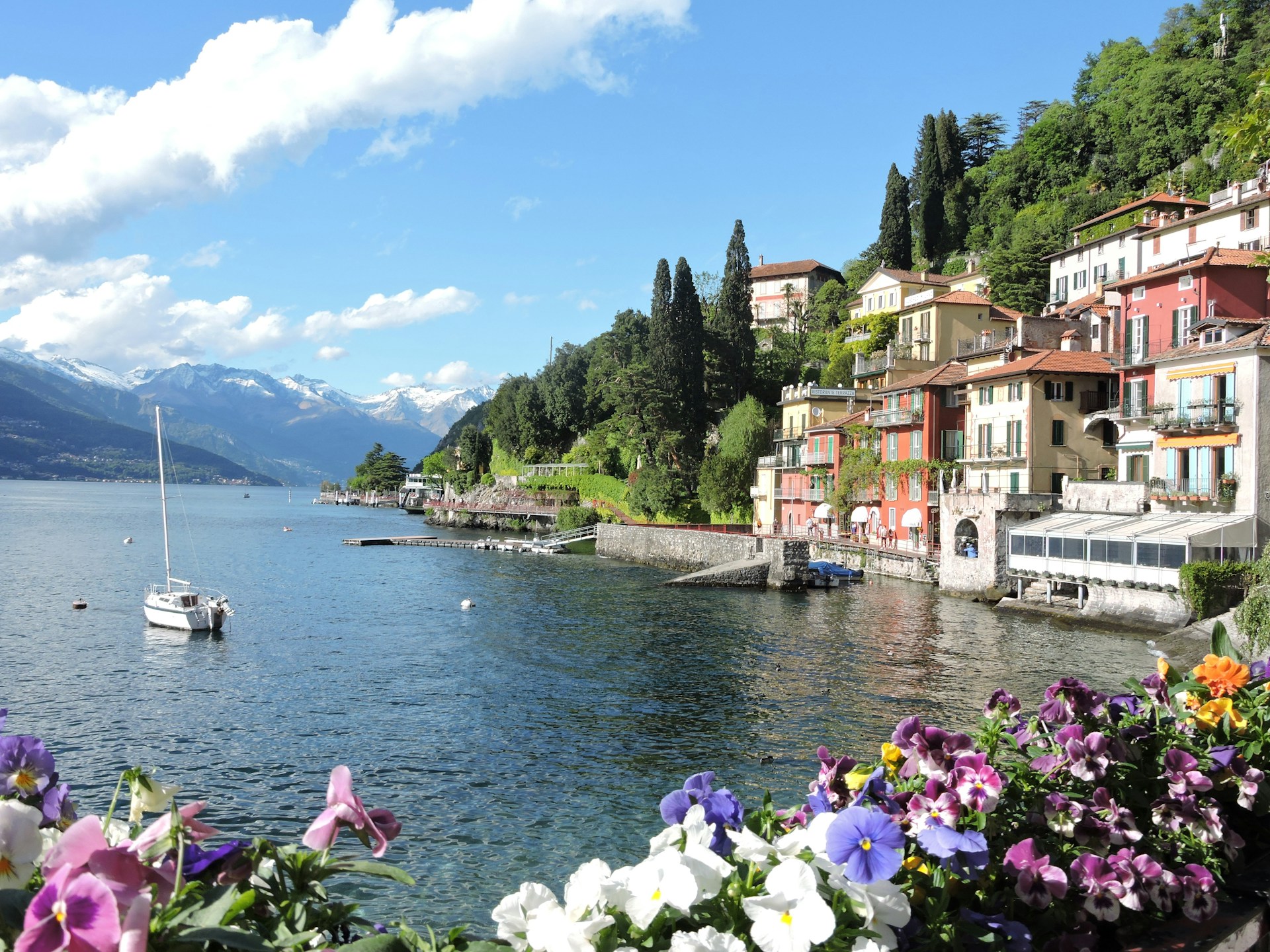An picturesque panoramic view of Varenna, a colorful village nestled on the steep shores of Lake Como, Italy